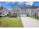Inviting two-story home with a welcoming front porch, lush green lawn, and a spacious driveway leading to a two-car garage at 403 Fox Sparrow Ct, Summerville, SC 29486