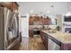 Modern kitchen featuring stainless steel appliances, granite countertops, and dark wood cabinets for ample storage at 403 Fox Sparrow Ct, Summerville, SC 29486