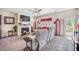 Cozy living room with a fireplace, large sectional sofa, and lots of natural light from the windows and sliding glass doors at 403 Fox Sparrow Ct, Summerville, SC 29486