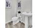 Clean and simple bathroom with a pedestal sink, toilet, and modern decor at 4115 Rising Tide Dr, Summerville, SC 29485