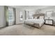 Serene bedroom featuring a large bed, neutral decor, and natural light from two windows at 4115 Rising Tide Dr, Summerville, SC 29485