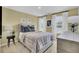 Bright bedroom with muted yellow walls, framed art, and natural light from two windows at 4115 Rising Tide Dr, Summerville, SC 29485