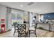 Dining area with a glass table, modern chairs, and sliding doors to the backyard at 4115 Rising Tide Dr, Summerville, SC 29485
