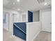 Upstairs hallway with a blue accent wall and white trim at 4115 Rising Tide Dr, Summerville, SC 29485