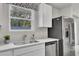 Bright kitchen featuring stainless steel appliances, white countertops, and a window overlooking the yard at 4115 Rising Tide Dr, Summerville, SC 29485