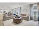 Spacious living room with two sofas, geometric rug, and view into the kitchen and dining area at 4115 Rising Tide Dr, Summerville, SC 29485