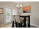 Dining area with stylish table and chairs near a door with exterior views, and unique wall art at 4143 Rigsby Ln, Charleston, SC 29414