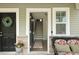 Inviting entryway with an open door, stairs leading up, and lovely decorated with a wreath and seating at 4143 Rigsby Ln, Charleston, SC 29414