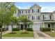 Attractive townhome featuring well-manicured landscaping, a one car garage, and a welcoming front entrance at 4143 Rigsby Ln, Charleston, SC 29414