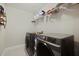 Brightly lit laundry room with modern washer and dryer set with shelving for storage at 4143 Rigsby Ln, Charleston, SC 29414