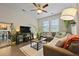 Cozy living room with comfortable seating, a large television, and lots of decorative houseplants at 4143 Rigsby Ln, Charleston, SC 29414