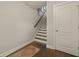 Staircase with wood treads and a modern rug, complemented by a white door and neutral wall color at 4143 Rigsby Ln, Charleston, SC 29414