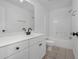 Bathroom featuring white cabinets, matching sink with black fixtures and a shower at 4735 Arco Ln, North Charleston, SC 29418