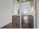 Bathroom shower featuring stone walls, glass door, and bronze fixtures with a window view at 4735 Arco Ln, North Charleston, SC 29418