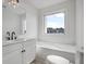 Bathroom featuring a white vanity and bath with a large window and neighborhood view at 4735 Arco Ln, North Charleston, SC 29418