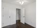 Bright bedroom with dark hardwood floors, white walls, ceiling fan and two door access points at 4735 Arco Ln, North Charleston, SC 29418