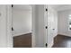 Bedroom view through an open door showing dark floors and freshly painted white walls at 4735 Arco Ln, North Charleston, SC 29418
