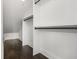 White closet with dark wood floors and closet rods in an attic bedroom at 4735 Arco Ln, North Charleston, SC 29418