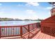 Spacious deck with wooden railings offers a tranquil waterfront view, perfect for enjoying the outdoors at 4735 Arco Ln, North Charleston, SC 29418