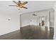Expansive living room with dark hardwood floors, ceiling fans, and natural light from multiple windows at 4735 Arco Ln, North Charleston, SC 29418