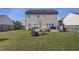 Spacious backyard with a deck, fire pit, and lush lawn, great for outdoor living at 500 Dolphin Dr, Summerville, SC 29485