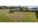 Large fenced backyard with a mature lawn and seating area at 500 Dolphin Dr, Summerville, SC 29485
