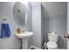 The half bath features a pedestal sink, white toilet, and grey walls at 500 Dolphin Dr, Summerville, SC 29485