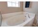 Bright bathroom featuring a soaking tub under a window and a towel at 500 Dolphin Dr, Summerville, SC 29485