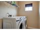 Bright laundry room with Samsung washer and dryer and overhead shelving at 500 Dolphin Dr, Summerville, SC 29485