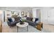 Open-concept living room with a gray couch, white coffee table, and decor at 5024 Scow Ct, Summerville, SC 29485