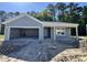 Charming single-story home with light gray siding and an attached garage, set against a backdrop of trees at 5031 Scow Ct, Summerville, SC 29485