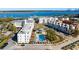 Aerial view of residential buildings featuring a pool, lush landscaping, and water views at 508 Helmsman St, Charleston, SC 29492