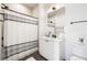 The well-lit bathroom offers a tub/shower combo, a modern vanity, and sleek black fixtures for a modern aesthetic at 508 Helmsman St, Charleston, SC 29492
