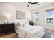 This bright bedroom features a neutral palette, ceiling fan, and large windows for a relaxing space at 508 Helmsman St, Charleston, SC 29492