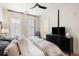 Relax in this main bedroom with an ensuite bathroom, a ceiling fan, bright windows and large TV at 508 Helmsman St, Charleston, SC 29492