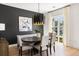 Contemporary dining room with stylish lighting, ample seating, and an adjacent window at 508 Helmsman St, Charleston, SC 29492