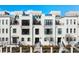 Modern townhome showcases a sleek white facade, black-framed windows, and a well-manicured front yard at 508 Helmsman St, Charleston, SC 29492