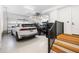 Spacious three car garage with epoxy floor and containing multiple parked vehicles, interior stairs, and storage at 508 Helmsman St, Charleston, SC 29492