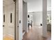 Hallway featuring hardwood floors, elevator access, and a view into the dining area at 508 Helmsman St, Charleston, SC 29492
