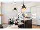 Modern kitchen island with white countertops and black pendant lights at 508 Helmsman St, Charleston, SC 29492