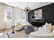 Elegant living room featuring a statement chandelier, modern art, and stylish seating at 508 Helmsman St, Charleston, SC 29492