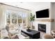Bright living room with fireplace, large windows, and stylish furniture creates a cozy and inviting atmosphere at 508 Helmsman St, Charleston, SC 29492