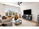 Bright living room with modern furniture, a large window, and a ceiling fan at 508 Helmsman St, Charleston, SC 29492