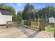 Exterior view of a wooden backyard deck, with green trees and grass at 520 Givhans Rd, Ridgeville, SC 29472