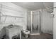 Functional utility bathroom featuring a shower, toilet, sink, and shelving at 520 Givhans Rd, Ridgeville, SC 29472