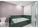 Bathroom features a large soaking tub with green tile surround and a glass-enclosed shower at 520 Givhans Rd, Ridgeville, SC 29472