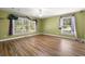 Bedroom with neutral walls, wood floors, large windows with coverings, and ceiling fan at 520 Givhans Rd, Ridgeville, SC 29472