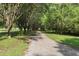 Gravel driveway lined with trees provides a scenic entrance to the property at 520 Givhans Rd, Ridgeville, SC 29472