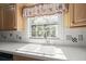 Bright kitchen view highlighting double sink with window, and decorative rooster valance at 520 Givhans Rd, Ridgeville, SC 29472