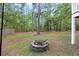 Landscaped backyard features a stone fire pit, mature trees and plenty of space for outdoor activities and gatherings at 521 Sanders Farm Ln, Wando, SC 29492